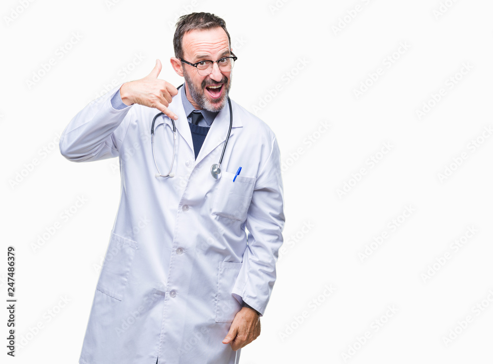 Middle age senior hoary doctor man wearing medical uniform isolated background smiling doing phone gesture with hand and fingers like talking on the telephone. Communicating concepts. Middle age senior hoary doctor man wearing medical uniform isolated background smiling doing phone gesture with hand and fingers like talking on the telephone. Communicating concepts.