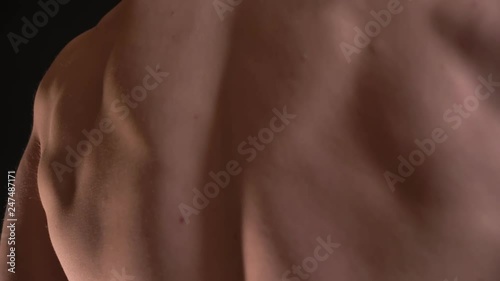 Wallpaper Mural Dolly shot from bottom to top of male muscular back on black background. Torontodigital.ca