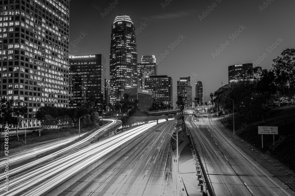 Traffic on the 110 Freeway and the Los Angeles Skyline at night, seen from the 4th Street Bridge, in downtown Los Angeles, California.