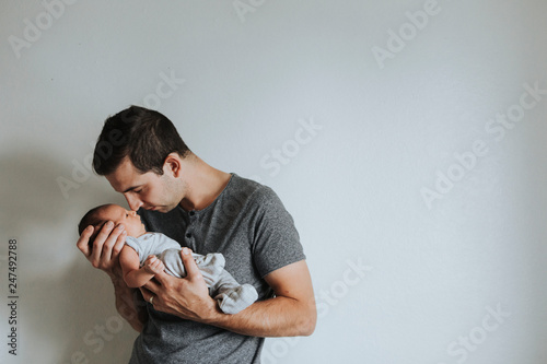 Quadro su tela Young father holding his baby