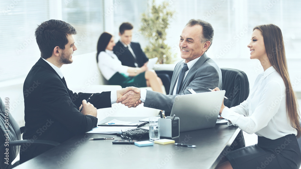 business partners are discussing a plan of cooperation in the workplace in the office business partners are discussing a plan of cooperation in the workplace in the office