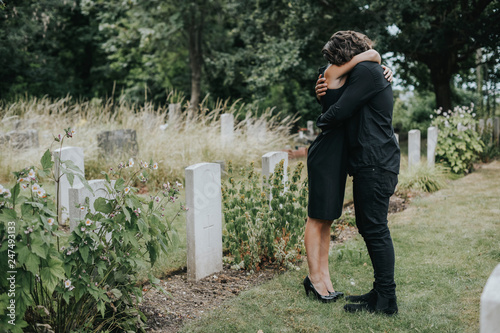 Photography Husband trying to comfort his wife at a graveyard