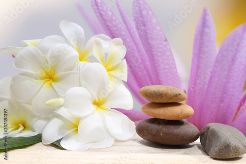Zen spa concept background - Zen massage stones with frangipani plumeria flower