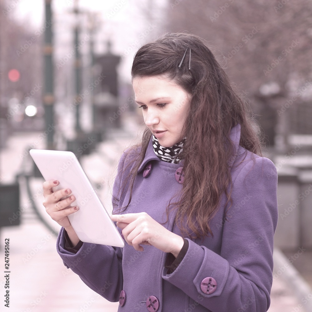 smiling woman using digital tablet standing on city street smiling woman using digital tablet standing on city street