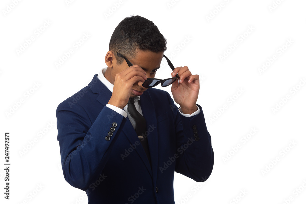 Hispanic Boy Dressed in Suit and Putting on Sun Glasses Hispanic Boy Dressed in Suit and Putting on Sun Glasses