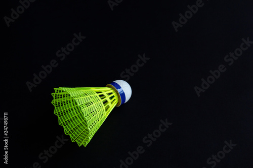 Plastic shuttlecock on black background.