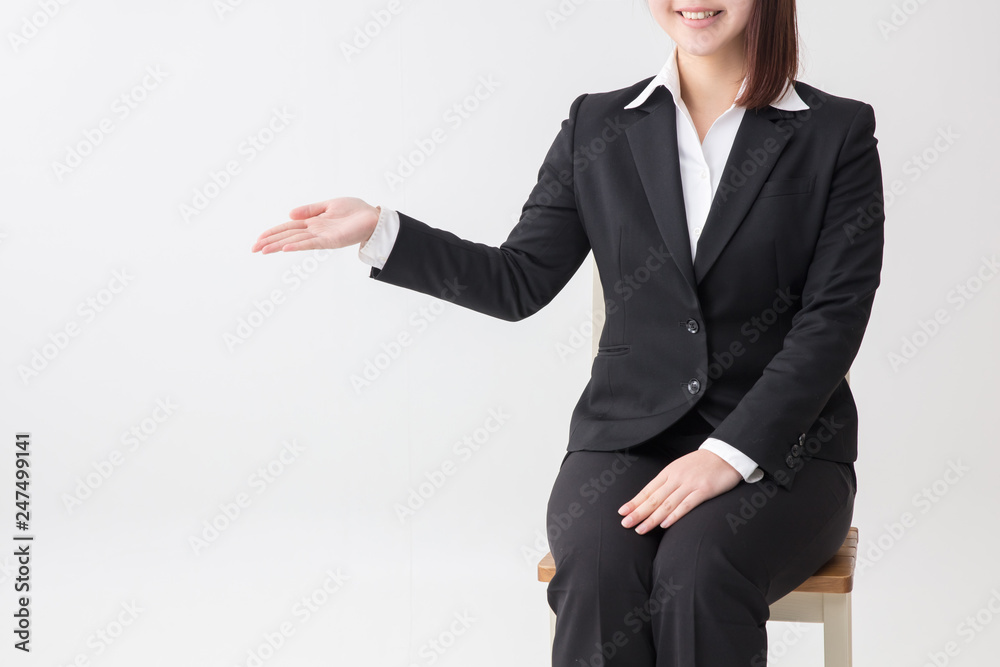 椅子に座ったスーツの若い女の子 椅子に座ったスーツの若い女の子