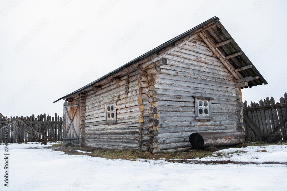 wooden house, frame, old, decrepit, in the field in winter
