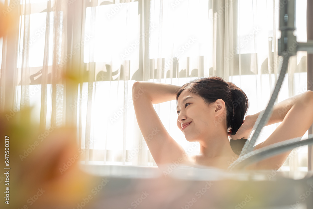 Young beautiful Asian woman taking bath in bathtub, massaging perfect skincare Young beautiful Asian woman taking bath in bathtub, massaging perfect skincare