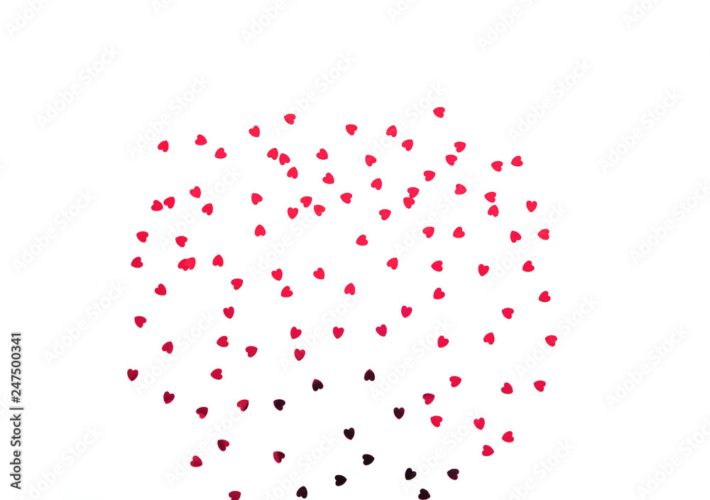 Festive white background with red spangles in the shape of heart. Festive white background with red spangles in the shape of heart.