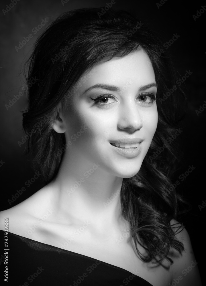 Portrait of a beautiful brunette on a dark background. Portrait of a beautiful brunette on a dark background.