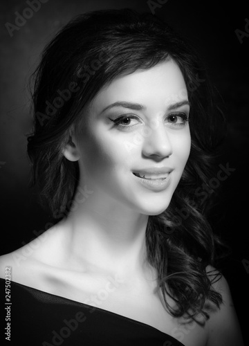 Portrait of a beautiful brunette on a dark background.