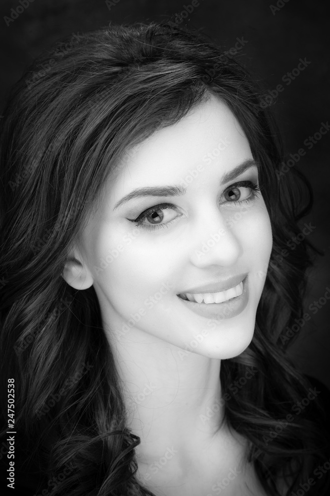 Portrait of a beautiful brunette on a dark background. Portrait of a beautiful brunette on a dark background.