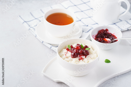 Healthy breakfast with rice porridge and cranberry confiture.