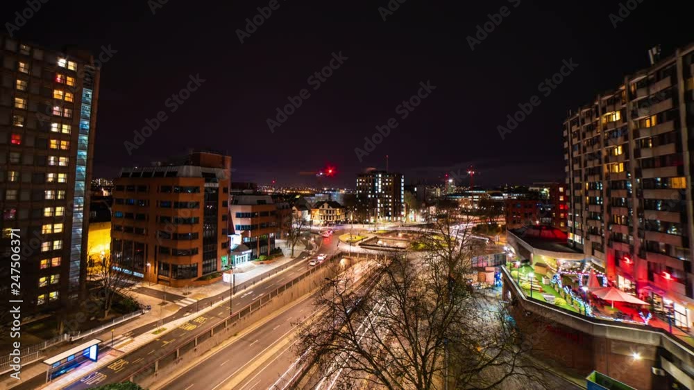Time lapse of traffic light trails passing lit up skyscraper buildings at night Time lapse of traffic light trails passing lit up skyscraper buildings at night