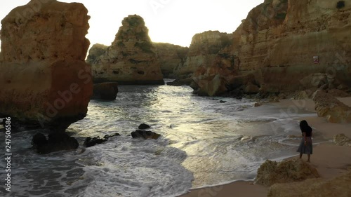a girl walking by the beach in algarve
