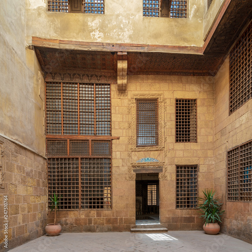 Facade of ottoman era historic house of Moustafa Gaafar Al Seleehdar, located at Al Darb Al Asfar District, Cairo, Egypt, with interleaved wooden windows (Mashrabiya) photo