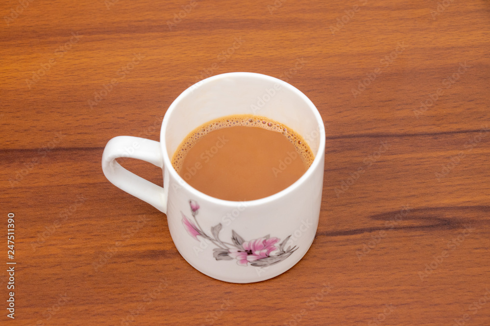 Cup of tea with milk isolated on wooden background Cup of tea with milk isolated on wooden background
