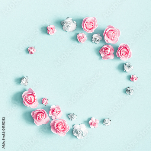 Flowers composition. Wreath made of rose flowers on pastel blue background. Valentines day, mothers day, womens day, spring concept. Flat lay, top view, copy space, square