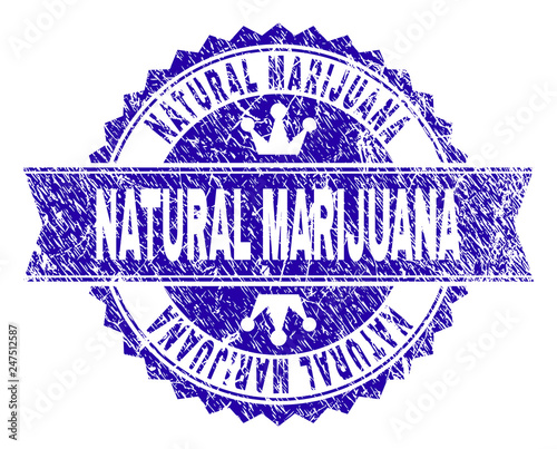 NATURAL MARIJUANA rosette stamp seal imprint with grunge texture. Designed with round rosette, ribbon and small crowns. Blue vector rubber print of NATURAL MARIJUANA title with grunge texture.