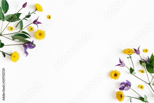 Flowers composition. Yellow and purple flowers on white background. Spring, easter concept. Flat lay, top view, copy space