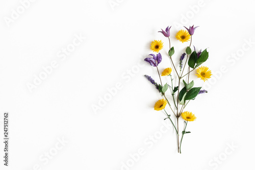 Flowers composition. Yellow and purple flowers on white background. Spring, easter concept. Flat lay, top view, copy space