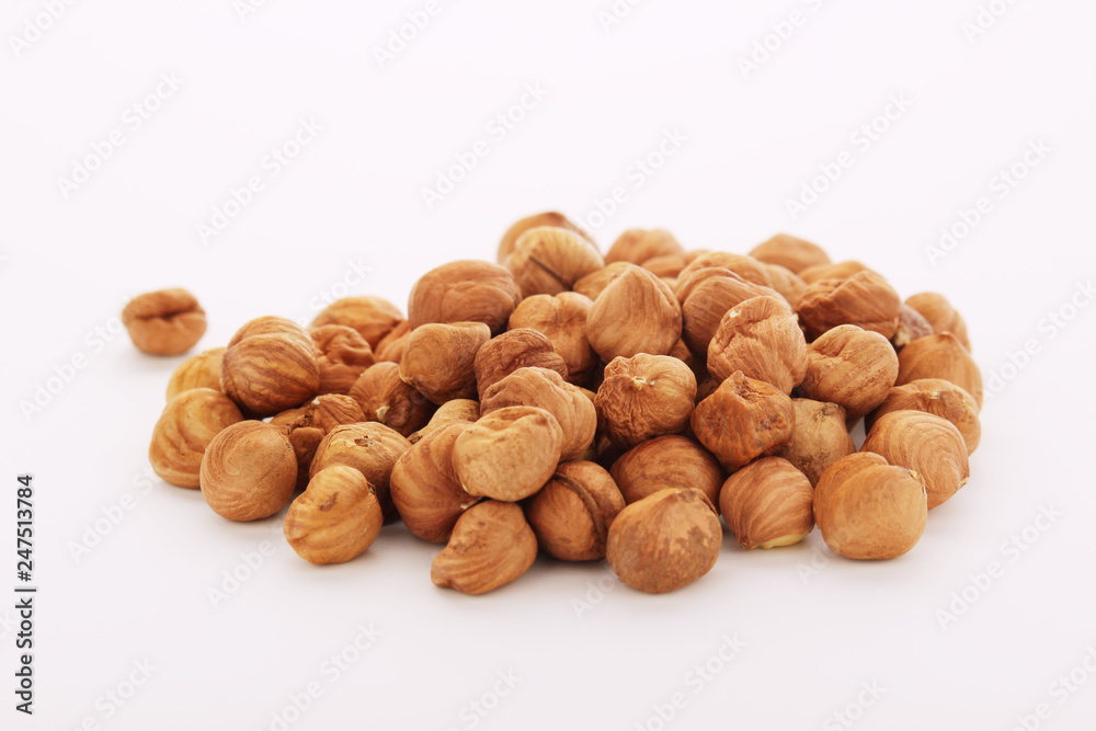 A pile of hazelnuts at white background A pile of hazelnuts at white background