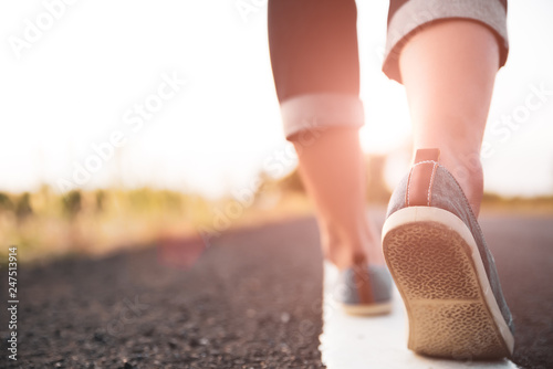 Closeup woman walking towards on the road side. Step concept.