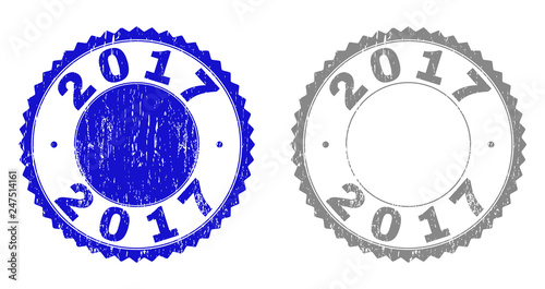 2017 stamp seals with distress texture in blue and grey colors isolated on white background. Vector rubber imprint of 2017 label inside round rosette. Stamp seals with unclean styles.
