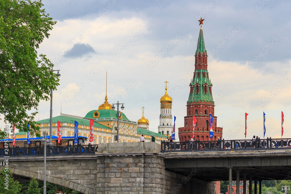 Buildings of Moscow Kremlin on a background of Bolshoy Kamenny Bridge over Moskva river in cloudy day