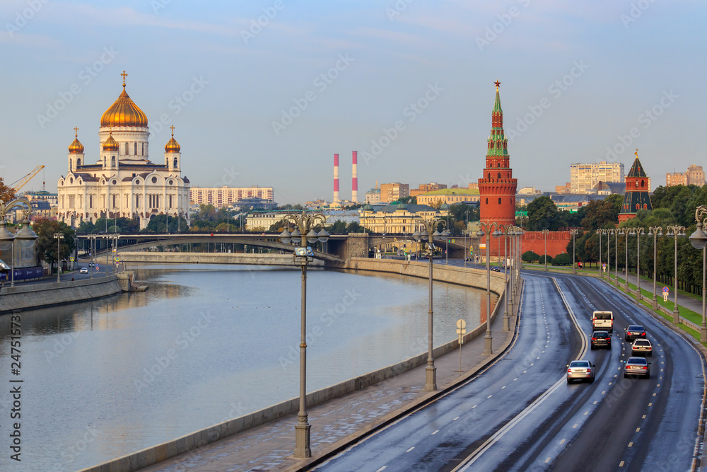 Kremlevskaya embankment of Moskva river on a background of Cathedral of Christ the Saviour and Moscow Kremlin in sunny early morning
