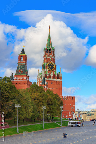 Towers of Moscow Kremlin in sunny day against blue sky with white clouds