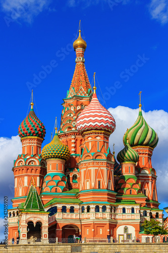 Architecture of St. Basil's Cathedral in Moscow against blue sky with clouds in sunny day