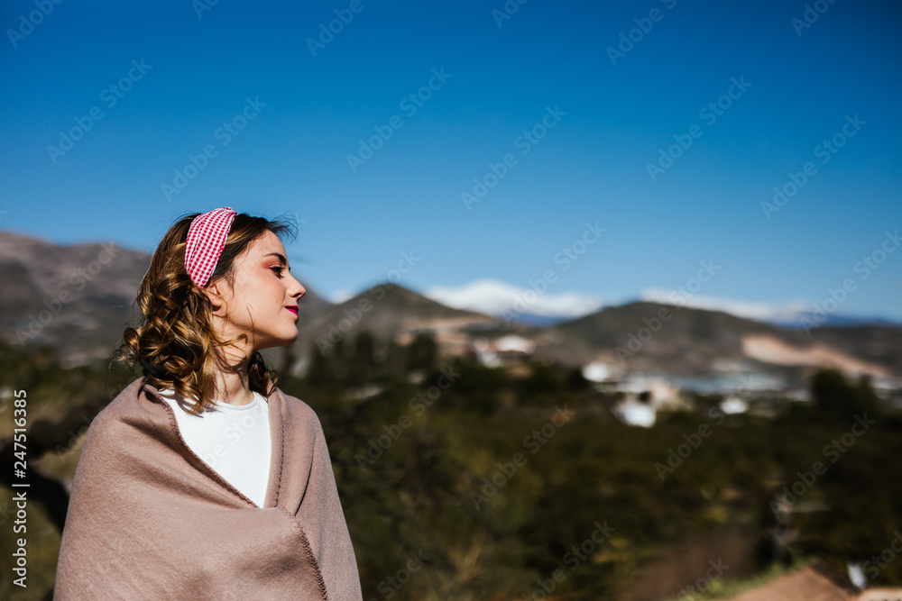 Young Russian girl enjoys spring sun in the countryside