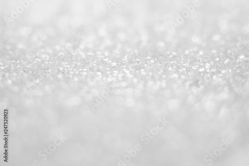 White blurry bokeh glitter abstract background.