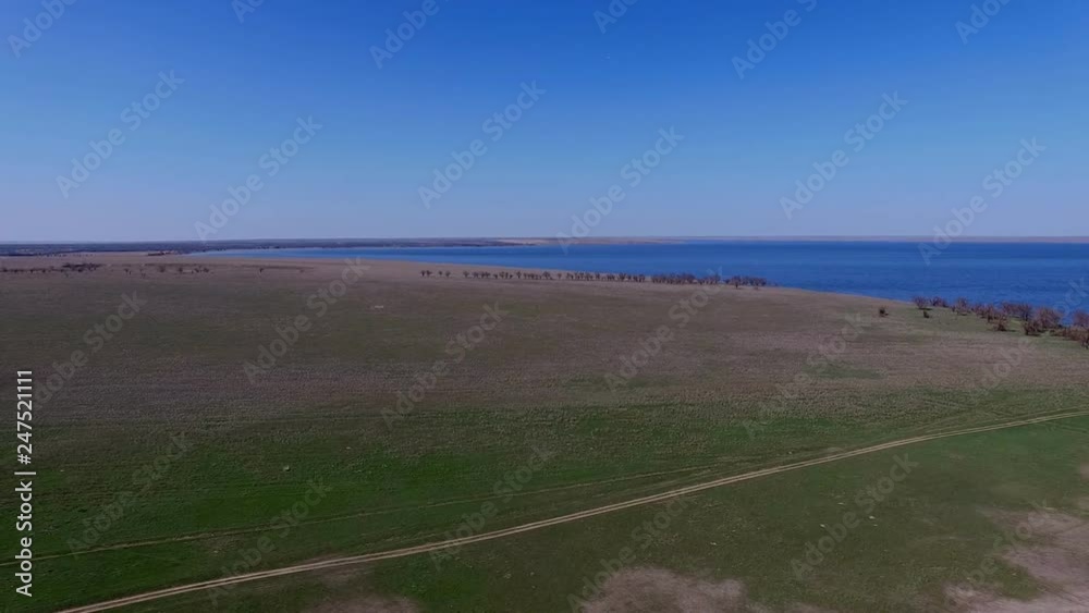 Flight over the road in the steppe. Panorama of the lake. Kazakhstan, Almaty. In the spring, a sunny day. Flight over the road in the steppe. Panorama of the lake. Kazakhstan, Almaty. In the spring, a sunny day.