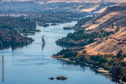 Sunset over the Nile River in the city of Aswan with sandy and deserted shores photo