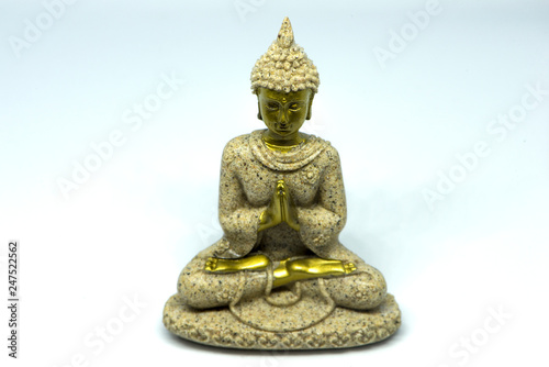 Buddha figure meditating on a white background