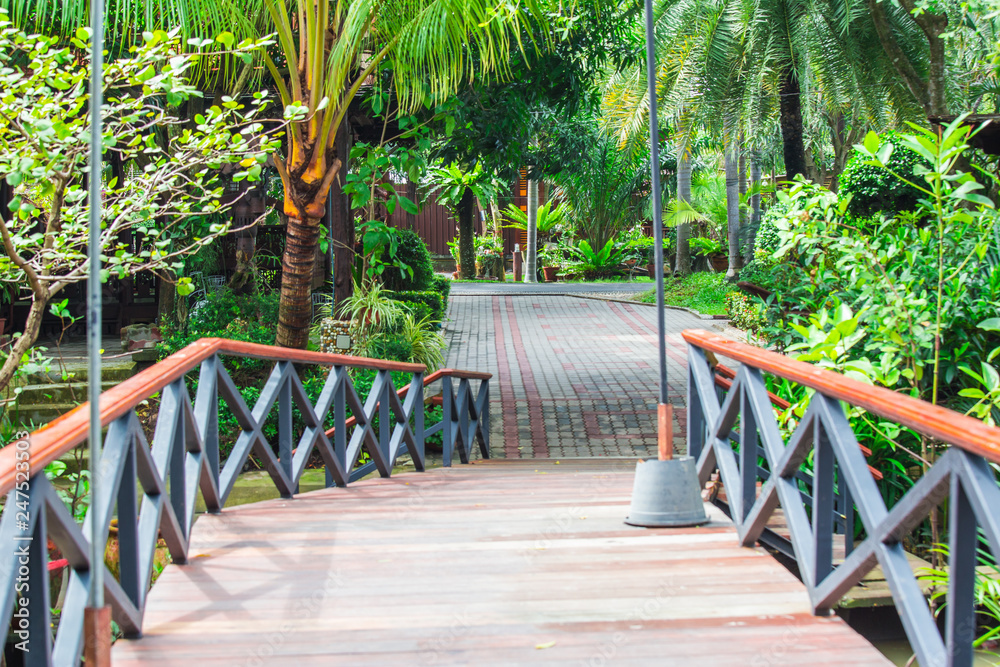 Road in the garden house with iron bridge park Road in the garden house with iron bridge park