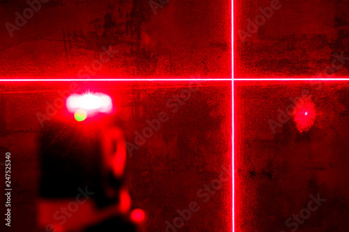red laser level. carving in a dark room. shallow depth of field