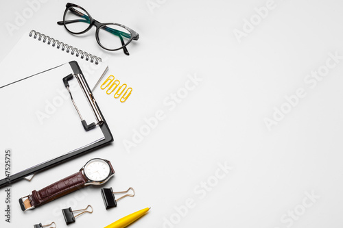 Clipboard with white sheet and pen isolated on a white background. Top view