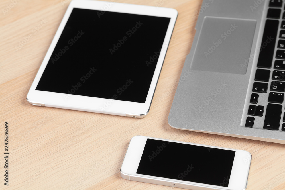 Open laptop with digital tablet and smartphone close up Open laptop with digital tablet and smartphone close up