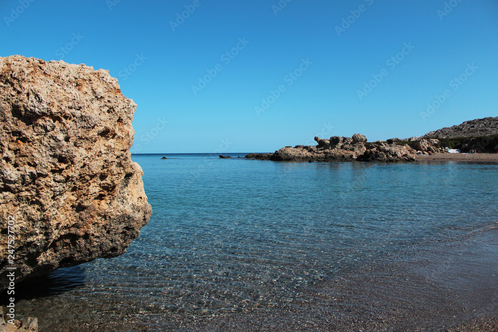 Perfect summer photo: crystal clear water, sea rocks, free copy space