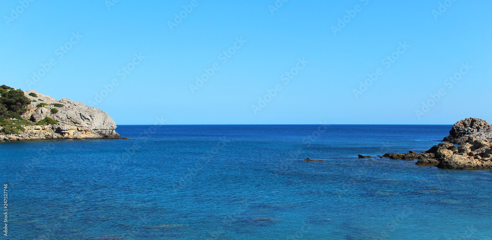 Beautiful seascape shot on one of the Greek islands, blue sea, fantastic sea rocks and clear sky