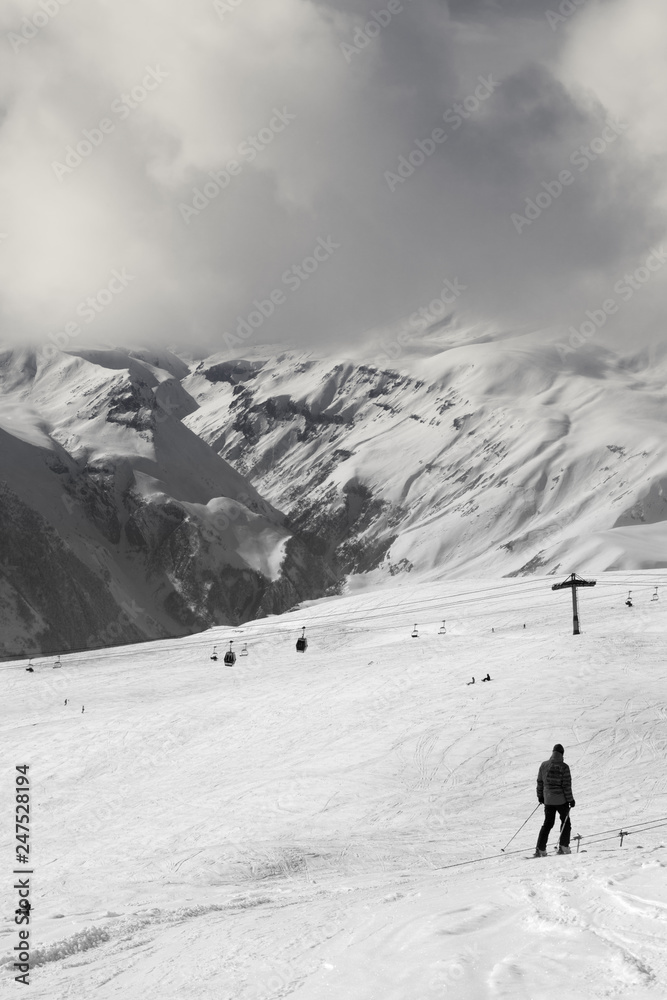 Skier descend on snowy ski slope