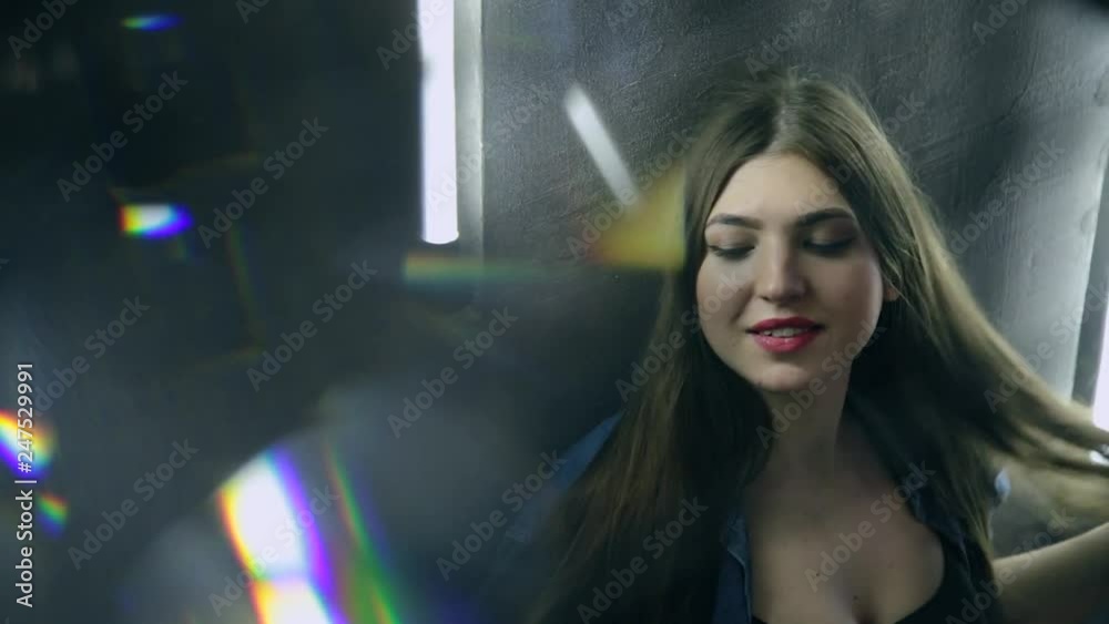 Beautiful attractive woman posing on the iron black ladder in loft style. Beautiful attractive woman posing on the iron black ladder in loft style.