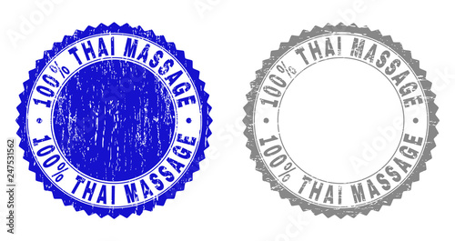 100% THAI MASSAGE stamp seals with distress texture in blue and grey colors isolated on white background. Vector rubber imprint of 100% THAI MASSAGE caption inside round rosette.