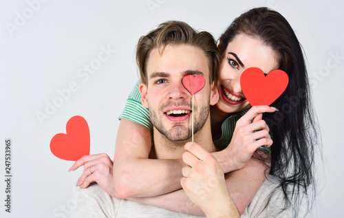 Man and woman couple in love hug and hold red heart valentines cards close up. Valentines day concept. Romantic ideas celebrate valentines day. Man and pretty girl in love. Valentines day and love