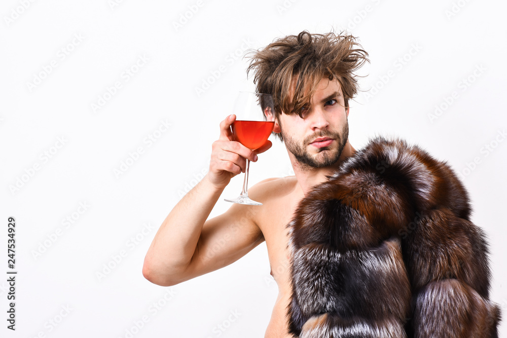 Rich athlete enjoy his life. Sexy sleepy rich macho tousled hair drink wine isolated on white. Health and wellbeing. Richness and luxury concept. Guy attractive rich posing fur coat on naked body Rich athlete enjoy his life. Sexy sleepy rich macho tousled hair drink wine isolated on white. Health and wellbeing. Richness and luxury concept. Guy attractive rich posing fur coat on naked body