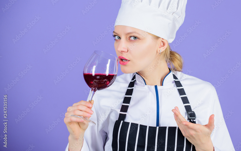 Wine degustation. Which wine to serve with dinner. How to pair wine and food like expert. Girl wear hat and apron enjoy aroma of drink. Woman professional chef hold glass of wine. Restaurant concept Wine degustation. Which wine to serve with dinner. How to pair wine and food like expert. Girl wear hat and apron enjoy aroma of drink. Woman professional chef hold glass of wine. Restaurant concept